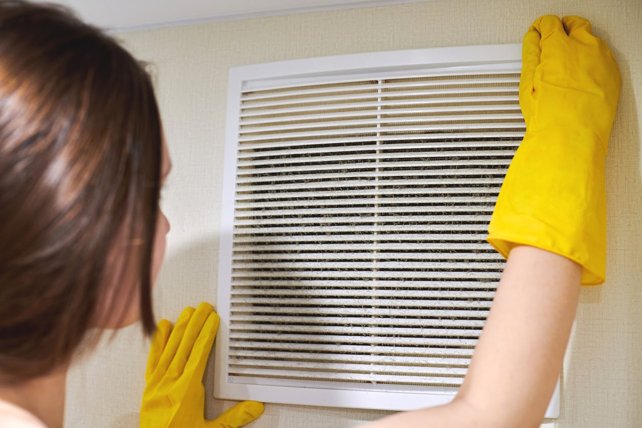 Woman cleaning air ducts